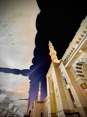 Electronic umbrellas in the Prophet's Mosque in Medina, the concept of worship and closeness to God, performing the obligatory prayer on time, a sacred religious place and landmark in the Kingdom of Saudi Arabia, design and decoration in the Islamic style.