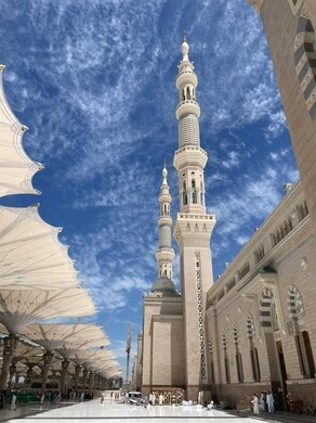 Electronic umbrellas in the Prophet's Mosque in Medina, the concept of worship and closeness to God, performing the obligatory prayer on time, a sacred religious place and landmark in the Kingdom of Saudi Arabia, design and decoration in the Islamic style.