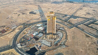 Jeddah Tower under construction, construction and concrete pouring works, construction cranes working on building a new facility in Saudi Arabia, infrastructure development concept, implementation of the reconstruction plan and shaping of the metal structure, heavy machinery and equipment, cranes and high scaffolding