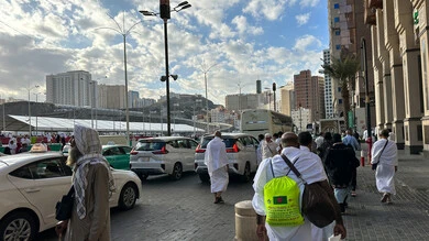 Visitors to the House of God in the streets surrounding the Grand Mosque in Mecca, sacred Islamic religious sites and landmarks in the Kingdom of Saudi Arabia, performing Hajj and Umrah rituals, pilgrims and Umrah performers strolling in the streets