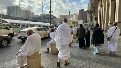 Visitors to the House of God in the streets surrounding the Grand Mosque in Mecca, sacred Islamic religious sites and landmarks in the Kingdom of Saudi Arabia, performing Hajj and Umrah rituals, pilgrims and Umrah performers strolling in the streets