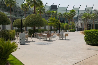 Outdoor seating area and urban garden at King Abdullah Financial District (KAFD) in Riyadh, achieving economic renaissance, leading banking companies, the ideal destination for finance and business in Saudi Arabia, modern architectural art for commercial buildings