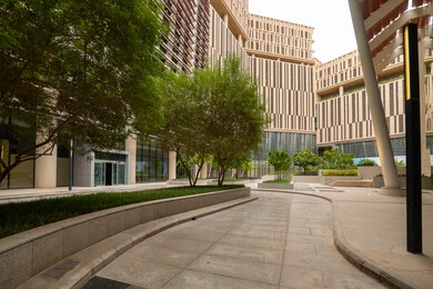 The outdoor plazas in front of King Abdullah Financial District (KAFD) in Riyadh during the day, achieving economic renaissance, leading companies in banking services, the ideal destination for finance and business in the Kingdom of Saudi Arabia, modern architectural art for commercial buildings