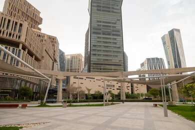 The outdoor plazas in front of King Abdullah Financial District (KAFD) in Riyadh during the day, achieving economic renaissance, leading companies in banking services, the ideal destination for finance and business in the Kingdom of Saudi Arabia, modern architectural art for commercial buildings
