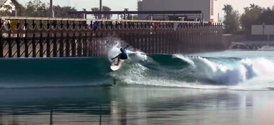 A recreational summer activity, a young man who plays surfing at sea, coastal tourist places in the United Arab Emirates, attracting and attracting tourists from all over the world, spending fun and entertaining time
