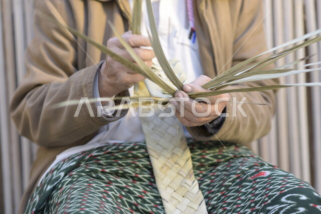  رجل كبير في السن عربي سعودي خليجي يتقن حياكة سعف النخيل, صناعة الخوص والسعف, مهن يدويه شعبيه