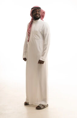 The feeling of self-confidence, standing upright and straight, a portrait of a Gulf Arab Saudi man wearing traditional attire looking at something with expressions of happiness and joy, full-body image, white background.