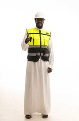 Gestures indicating agreement and acceptance, a portrait of a Saudi Gulf Arab engineer wearing traditional attire, a helmet, and a safety vest, pointing his thumb up with expressions of joy and happiness, working in the Saudi engineering sector, full-body image, white background.