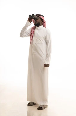 Seeing distant things through a telescope, gestures of enjoyment and pleasure, love of exploration and adventure, a portrait of a Saudi Arabian Gulf man wearing traditional attire and a ghutrah holding binoculars in his hand looking at something, full-body image, white background.