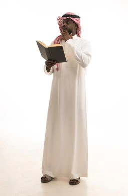 Expressions of thinking about something, the concept of literacy, the hobby of love for reading and exploration, spending free time on learning and culture, a portrait of a Saudi Arabian Gulf man wearing traditional attire and a ghutrah holding a scientific educational book in his hand, full-body, white background.