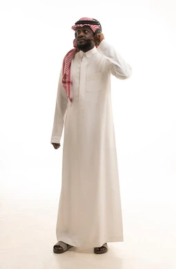 Responding to inquiries and requests, using headphones and advanced technologies at work, a portrait of a Saudi Arabian Gulf man wearing a ghutrah and traditional thobe, wearing headphones, working in the customer service department, communicating with customers to resolve issues and complaints, full-body image, white background.