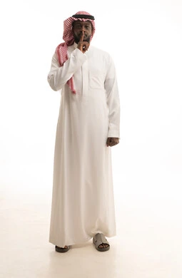 Stop talking and command silence and quiet, a portrait of an Arab Saudi Gulf man wearing traditional attire and a shemagh, raising his finger to his mouth in gestures asking for calm and not to be disturbed, looking at the camera with expressions of seriousness and determination, full body length, white background.