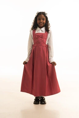 Gestures of refined literature and ethics, love of learning and teaching, return to school, a portrait of a Gulf Arab Saudi student wearing a school uniform, a Saudi student smiling and looking at the camera, preparation for the new school year, white background.