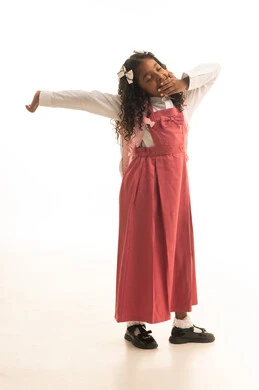 Feeling drowsy and tired during school hours, the desire for knowledge, preparing for the start of the school year, back-to-school season, a side portrait of a Saudi Gulf Arab student wearing a school uniform carrying a school bag, full body length, white background.