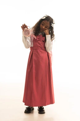 الشعور بالاحباط والملل لضيق الوقت, الاستعداد للعام الدراسي الجديد, التعليم في المملكة العربية السعودية, بورتريه لفتاة عربية خليجية سعودية ترتدي الزي المدرسي تمسك بيدها ساعة المنبه وتحمل الحقيبة المدرسية, خلفية بيضاء