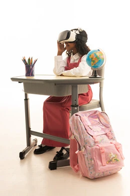 Education through the three-dimensional hologram feature, the evolution of teaching methods using modern technologies and simulating the imaginary world, a close-up portrait of a Saudi Gulf Arab girl wearing a school uniform and wearing three-dimensional virtual reality glasses, gestures of immersion and focus, white background.
