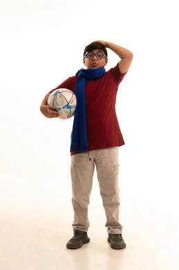 Gestures of loss and failure, enthusiasm and interaction with the national team, a portrait of a Saudi Arabian Gulf Arab boy wearing casual attire, red pants and a t-shirt, wearing a scarf and holding a football, different sports clubs, watching a World Cup match, full-body, white background.