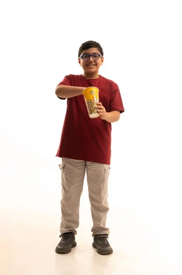Home entertainment activities, watching movies and theater shows, a portrait of an Arab Gulf Saudi boy wearing casual attire and glasses holding a bucket of popcorn, snacking and having light meals, full-body, white background.