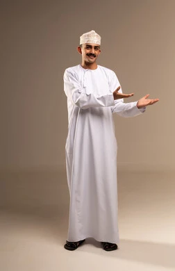 Greeting and welcoming someone, hand movements and gestures, greeting and peace and welcoming someone, a portrait of an Arab Gulf Omani man wearing a dishdasha and kumma, pointing with his hand towards something, gestures of lifting and carrying something, hand movements and gestures, full body, beige background.