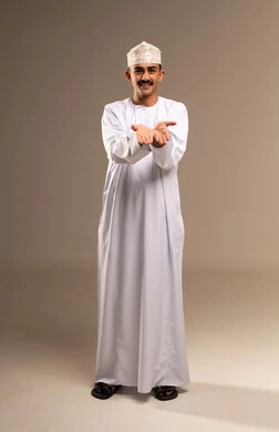 Hand movements and gestures, greeting and welcoming someone, greeting and peace and welcoming someone, a portrait of an Arab Gulf Omani man wearing a dishdasha and kumma, pointing with his hand towards something, gestures of lifting and carrying something, hand movements and gestures, full body, beige background.