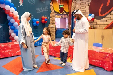 Feelings of fun and joy, the concept of entertainment and amusement, entertaining entertainment centers in the UAE, spending happy times in the land of fun, an Arab Gulf Emirati family enjoying playing in the amusement park, fun entertainment activities