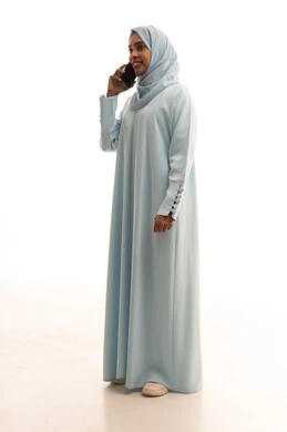 Communicating with family and friends, using modern technological devices in daily life, sharing news and good conversations, a portrait of a Saudi Arabian Gulf woman wearing a hijab and an abaya holding a mobile phone, making a phone call, full-body, white background.