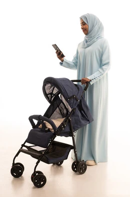 The importance of the mother and her essential role in raising and nurturing children, browsing smart applications on mobile phones, the concept of motherhood, care, and attention to children, a portrait of a Saudi Gulf Arab mother wearing an abaya and hijab pulling a stroller, going on outings and family tours, full-body image, white background.