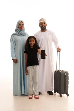 A black screen displayed on a mobile phone, a portrait of an Arab Gulf Omani woman wearing an abaya and hijab standing with her husband and daughter next to a suitcase, preparing to spend the summer vacation and go on a trip, a family atmosphere filled with love, full-body shot, white background.