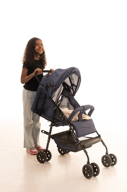 Looking up at something, strengthening the brotherly bond, spending enjoyable family time, the concept of a happy family, a portrait of a Gulf Arab Saudi girl wearing casual attire holding a stroller with gestures indicating happiness and love, full body, white background.
