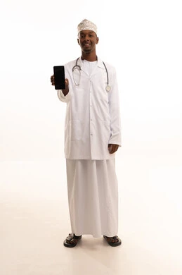 Display a blank black screen, using technology in research and development, providing services to patients efficiently, conducting remote medical consultations, a portrait of a young Arab Gulf Omani man with a dark complexion wearing a dishdasha and kumma with a white coat using a mobile phone, health professions and jobs, white background.