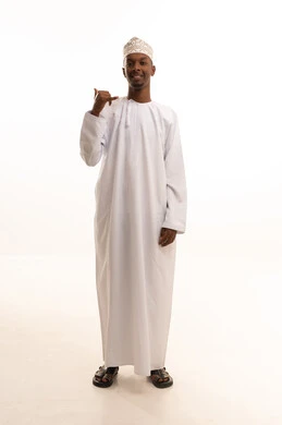 Receiving good news via mobile, the concept of information exchange, a hand gesture indicating communication, concern for appearance and attractiveness, a portrait of a dark-skinned Arab Gulf Omani man wearing a dishdasha and kumma raising his hand with gestures to answer phone calls, full body, white background.