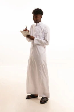 Organization and management of business, noting and recording observations and information on paper, a portrait of a young Arab Gulf Saudi man with a tan wearing a white thobe writing daily tasks and goals, white background.