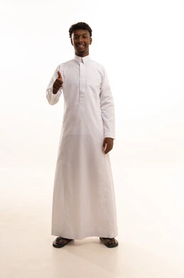 Acceptance, approval, and satisfaction, a sign of quality and excellence, a portrait of a young Arab Gulf Saudi man with a dark complexion wearing a white thobe, gesturing with his hand and facial expressions and hands indicating admiration, expressing quality and craftsmanship, with a white background.