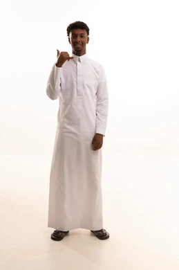 Receiving good news via mobile, the concept of information exchange, a hand gesture indicating communication, concern for appearance and attractiveness, a portrait of a young Arab Gulf Saudi man with a dark complexion wearing a white thobe raising his hand in gestures to answer phone calls, full body, white background.