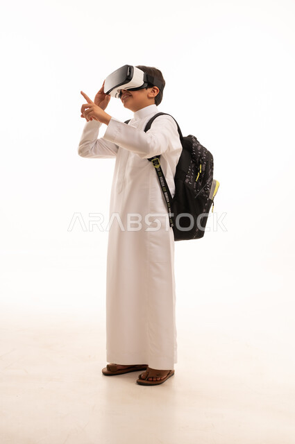 Virtual reality activities, cross-platform learning, virtual world simulation, portrait of a Saudi Arabian Gulf student wearing traditional thobe and school backpack, wearing VR glasses, full body image, white background