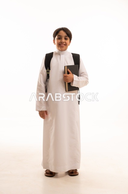 The concept of hard work to achieve success, educational scientific curricula, the concept of returning to school, a portrait of a Saudi Arabian Gulf student wearing traditional clothing, carrying a school backpack and holding a book in his hand, a full body image, a white background