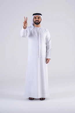Success and goal achievement, expressions of joy and happiness, portrait of an Emirati Gulf Arab man wearing a kandura and ghutra, looking at the camera with facial and hand gestures indicating victory and triumph.