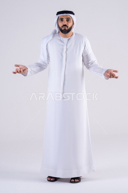 القلق والحيرة في اتخاذ القرار الصحيح،التفكير بعمق وشرود الذهن، محاولة إيجاد حل للمشكلات الصعبة، بورتريه لرجل عربي خليجي اماراتي يرتدي الكندوره والغتره يرفع يده بإيماءات عدم المعرفه