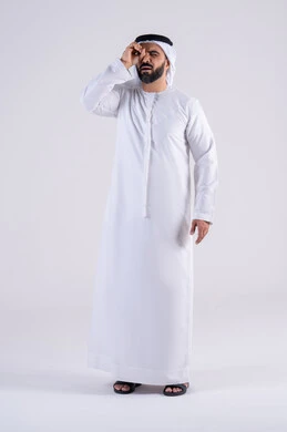 Activities to stimulate the mind and intellect, seeing distant objects with gestures of pleasure, a love of exploration and adventure. A portrait of an Arab Gulf Emirati man wearing a kandura and ghutra looking through his hand like a telescope.