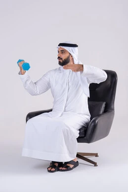 Weightlifting exercises (dumbbells), exercising with dumbbells, a portrait of an Arab Gulf Emirati man wearing a kandura and ghutra, lifting heavy iron weights, maintaining health and physical fitness.