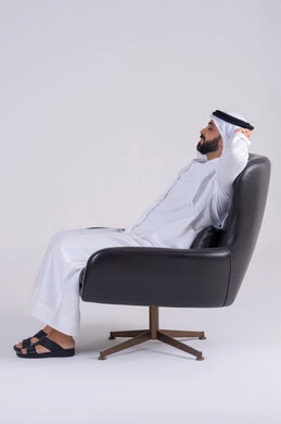 الإحساس بالكسل والخمول،الشعور بالتعب و الحاجه الى الراحه,  بورتريه لرجل عربي خليجي اماراتي يرتدي الكندوره والغتره يجلس على كرسي بإيماءات النوم، تعابير النعاس والإرهاق