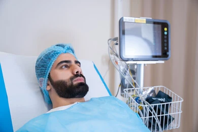 إيماءات الاندماج في التفكير, مريض عربي خليجي اماراتي مستلقي على سرير المستشفى, جهاز المونيتور لمراقبة نبضات القلب, أجهزة ومعدات طبية في غرفة العمليات