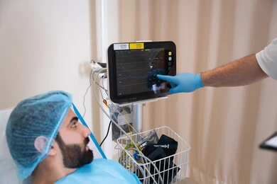 مريض عربي خليجي اماراتي في وضعية استرخاء أثناء مراقبة المؤشرات الحيوية, جهاز المونيتور لمتابعة نبضات القلب, أجهزة ومعدات طبية في غرفة العمليات, المراكز والمستشفيات والعيادات الصحية