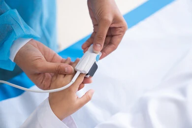 Monitoring patient vital signs, monitoring blood oxygen levels, integrating modern technology into the medical field, a doctor's hand examining a young boy, taking care of health conditions
