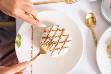 Local and national products and delicacies, almond ghriba cookies decorated with finely dusted sugar, stuffed maamoul pieces, delicious soft popular sweets, traditional hospitality during holidays and happy occasions, foods rich in sugar and calories, baked sweets with delicious flavors.