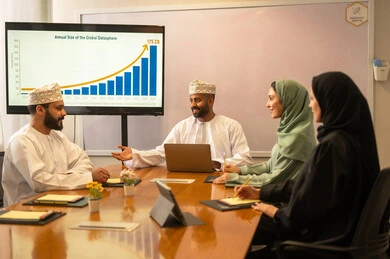 Collaboration and understanding among the team, exchanging experiences and successful agreements, organizing and managing the work concept schedule, a comfortable work environment in the Omani company, explaining the required tasks with happiness and love, a portrait of Arab Omani Gulf colleagues in a meeting to study statistical data, analyzing charts.