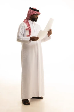 تعابير التفكير والتركيز، التدقيق في قراءة الملاحظات، اعداد التقارير الخاصة بالعمل، بورتريه لرجل عربي خليجي سعودي يرتدي الزى التقليدي والشماغ يحمل بيده مجموعة من الوثائق والاوراق البيضاء، مراجعة ومتابعة الخطط والمشاريع بإيماءات السعادة والسرور، خلفية بيضاء