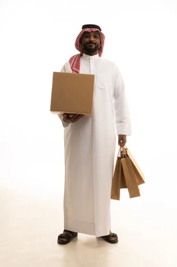 Reliable shipping and delivery process, fast delivery services, ordering and receiving delivery, portrait of an Arab Saudi Gulf man wearing traditional attire and a ghutrah working in delivering orders and goods to customers, online shopping and online orders, white background.