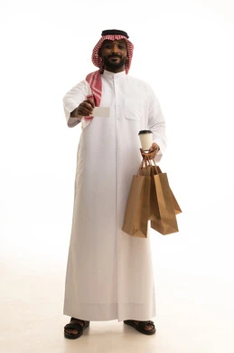 طلب وإستلام الدليفري, الاستمتاع بالمشروبات الساخنه ، عملية شحن وتوصيل موثوقه, خدمات التوصيل السريع, بورتريه لرجل عربي سعودي خليجي يرتدي الزى التقليدي والشماغ يمسك بيده كوب من القهوة يعمل في توصيل الطلبات والبضائع للزبائن, التسوق الالكتروني وطلبات اونلاين, خلفيه بيضاء