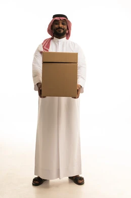 Fast delivery services, reliable shipping and delivery process, ordering and receiving delivery, portrait of an Arab Saudi Gulf man wearing traditional attire and a ghutrah working in delivering orders and goods to customers, online shopping and online orders, white background.
